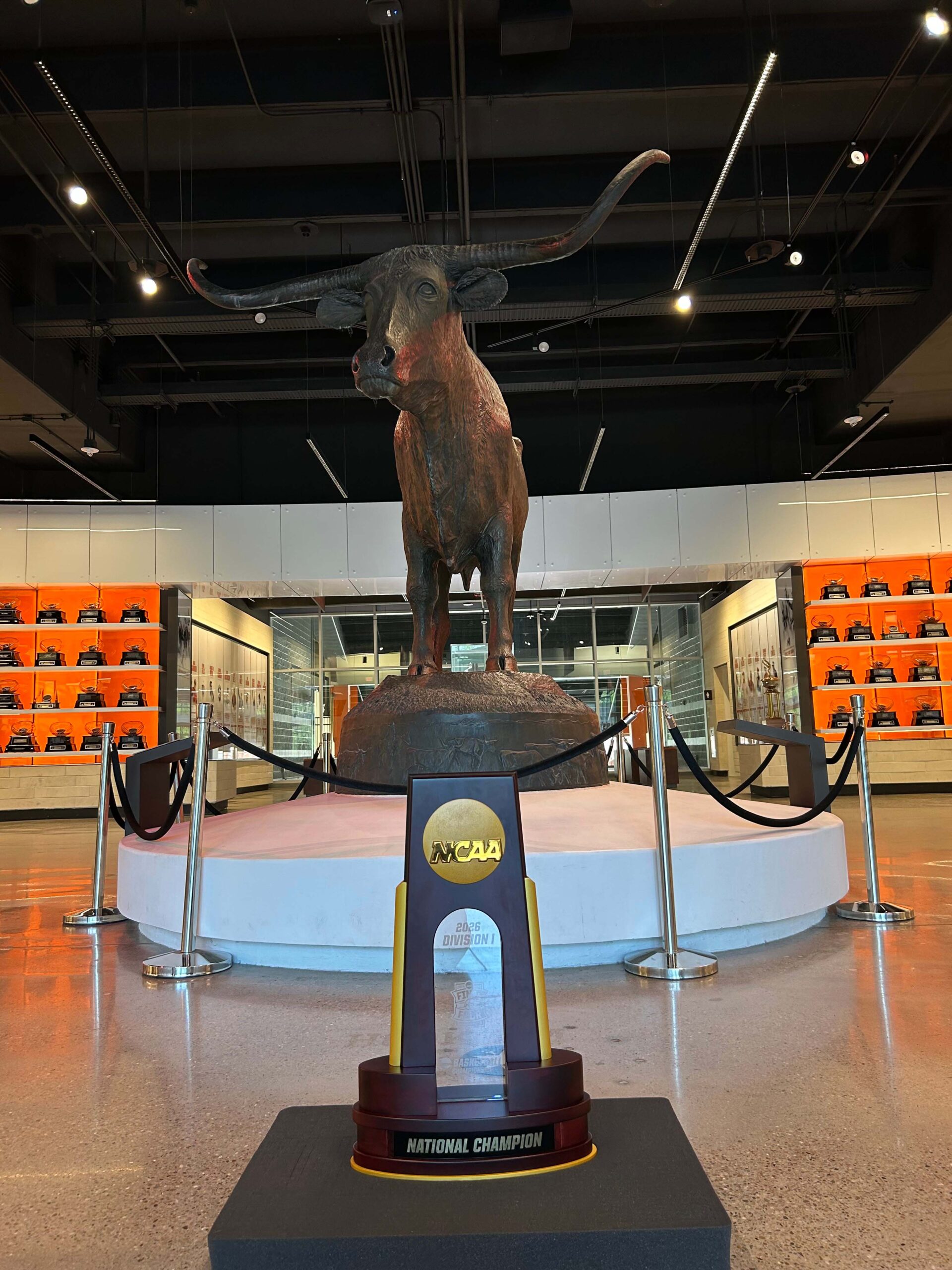 The 2026 Men's Final Four Trophy at the University of Texas at Austin in front of a Longhorn statue.